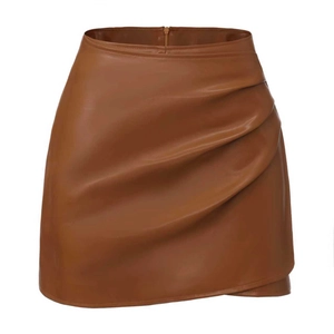 Detail view of the caramel brown PU leather skirt featuring ruched sides and side zipper