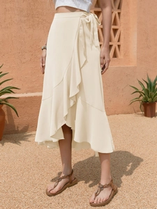 Detail of ruffle hemline and waist tie on a cream-colored wrap midi skirt for women