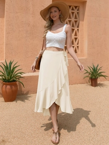 Detail view of the elegant beige wrap skirt featuring flowing ruffles and a waist tie design