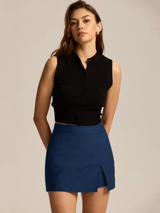 Detail of high-waist mini skirt with side slit and premium stretch fabric texture