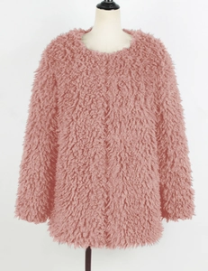 Détail de la texture douce d'une veste en fausse fourrure rose sur un mannequin