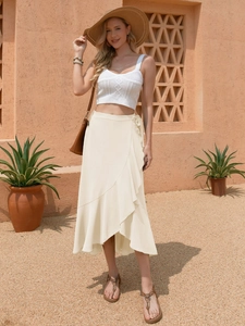 Detail of ruffle wrap midi skirt with tie waist paired with a white knit crop top