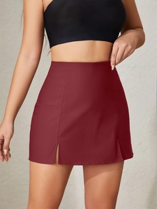 Detail view of burgundy high-waisted mini skirt featuring stylish front double slits