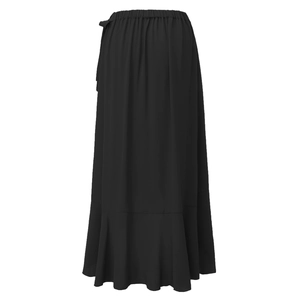 Detailed view of the ruffle hem and fluid black fabric on high waist long skirt
