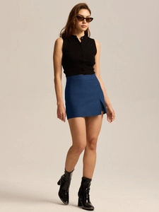Detail of high waist dark blue mini skirt with a stylish side slit and zip closure