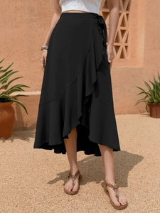 Close-up of black wrap midi skirt with ruffle hem and side tie bow detail for summer
