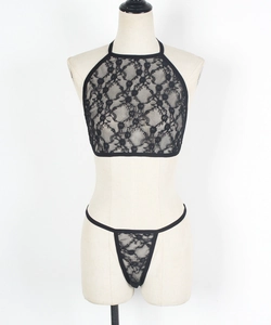 Detailed close-up of black lace lingerie set featuring halter neck bra and thong details