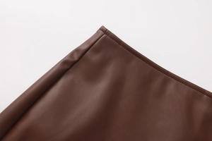 Detail view of premium dark brown PU leather showing high-quality stitching and smooth texture