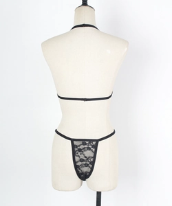 Detail of black lace lingerie set with halter neck top and thong on mannequin
