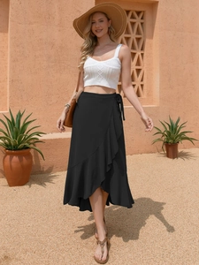 Detail of the asymmetric ruffle hem on this black wrap skirt for a bohemian vacation look