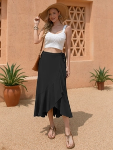 Detail of black wrap midi skirt with ruffles and tie-waist on a female model