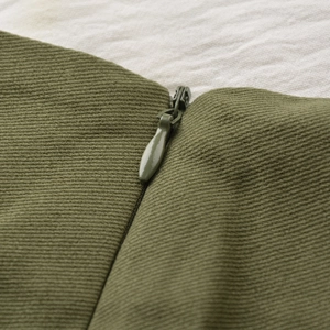 Close-up of military green skort detail featuring a hidden zipper and twill fabric
