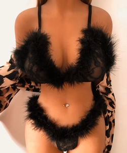 Detail of black lace lingerie set with fluffy feather trim and leopard print robe