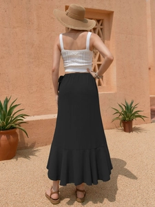Detail of black ruffled midi skirt hem with elegant tiered frill and lightweight fabric