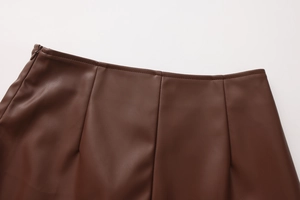 Detail of high waist PU leather skirt with hidden side zipper and vertical stitching