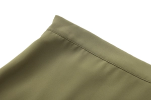 Macro shot of olive green ruffled skirt detail showing high-quality stitching and fabric