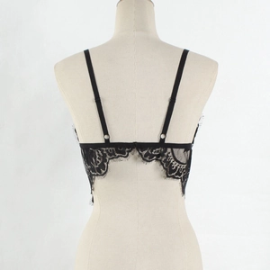 Close-up of black floral lace bra with intricate eyelash trim and adjustable straps