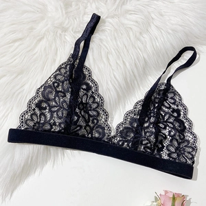 Elegant black lace French bralette with triangle cups and floral patterns on white fur