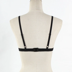 Detail view of black elastic strappy harness bra accessory with adjustable buckles