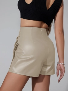 Detail showing the pleated side texture and high-waist fit of the khaki PU leather shorts