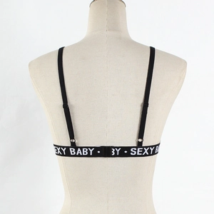 Detail of black sports bra back with white SEXY BABY elastic letters and adjustable straps