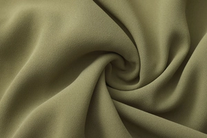 Detailed macro view of olive green chiffon fabric with fine grainy texture and soft drape