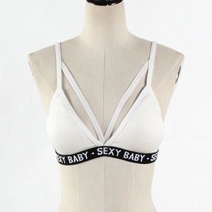 Detail of white sports bra featuring sexy baby lettered elastic band and cross straps
