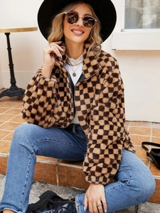 Close-up of brown checkerboard faux fur jacket texture with metal zipper detail