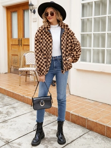 Detail of checkered faux fur jacket with warm plush texture and stylish zipper collar