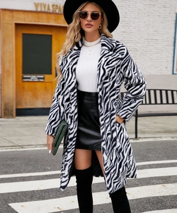 Detail of zebra print faux fur coat with lapel collar and soft plush texture
