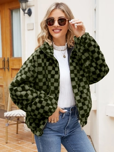 Close-up of green checkerboard faux fur texture with high collar and metal zipper detail
