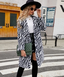 Detail of a chic zebra print faux fur coat featuring a classic notched lapel collar