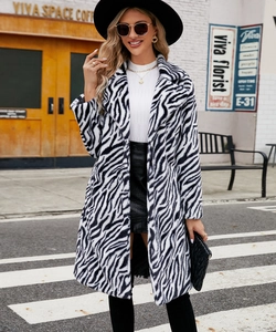 Detailed view of women's zebra print faux fur coat with a large lapel collar for autumn fashion