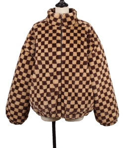 Detail of checkered faux fur jacket featuring a high collar and metal zip closure