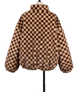 Back view of brown and beige checkerboard faux fur jacket with elastic hem and stand collar