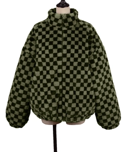 Detail of green and black checkerboard faux fur jacket with high collar and full zip