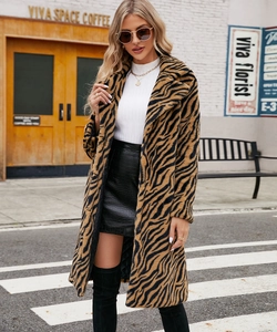 Detail of tiger print faux fur coat with lapel collar and plush texture for winter
