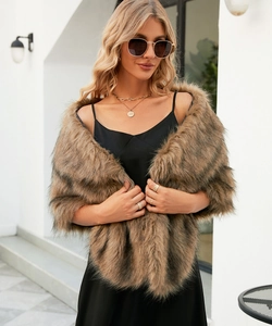 Detailed texture of brown faux fur shawl styled over a black dress for autumn fashion