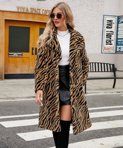 Outdoor street view of a stylish tiger pattern faux fur coat with high-collar white sweater