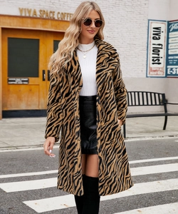 Detail of tiger print faux fur coat with oversized lapel collar and soft texture