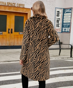 Close-up of zebra pattern faux fur texture and lapel design on mid-length winter coat