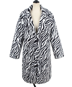 Detail of classic black and white zebra pattern on faux fur coat with notch lapel
