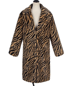 Detail of lapel collar and plush tiger stripe faux fur texture on long winter coat