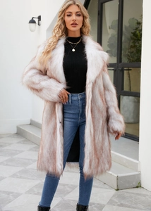 Detailed view of white and brown faux fox fur coat with a wide lapel on a model
