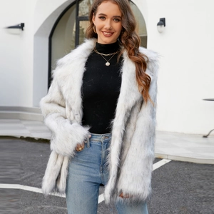 Close-up of white faux fur coat featuring a wide lapel collar and fluffy texture