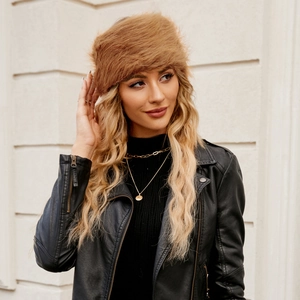 Close-up of fluffy faux fur brown Cossack hat texture on a model wearing leather