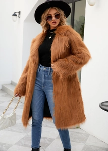 Chic long brown faux fox fur coat styled with black hat and jeans in street view