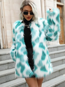 Detail view of teal and white patchwork faux fur coat with soft texture and vibrant contrast