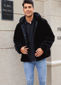 Detailed view of luxury black faux fur hooded jacket with premium plush texture and zipper