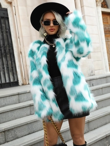 Detail of teal and white faux fox fur coat texture with geometric marble pattern